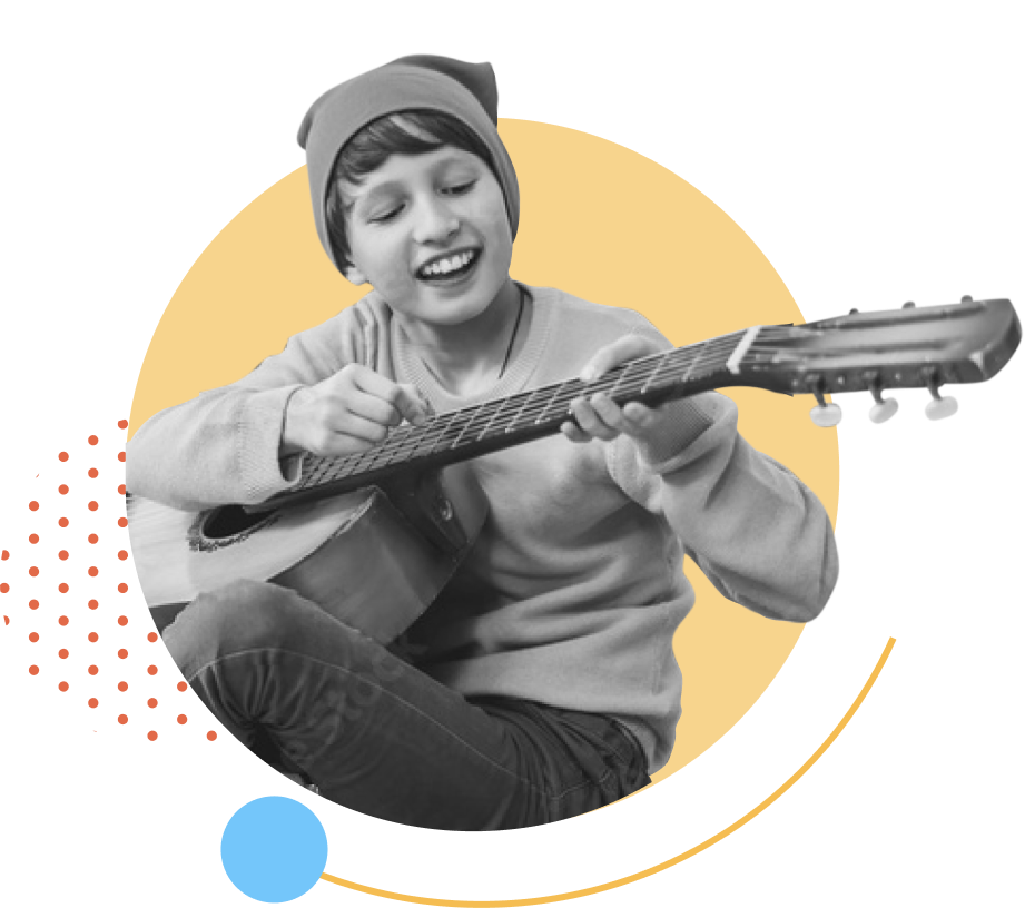 Child happily playing guitar during a 1-on-1 virtual guitar lesson.